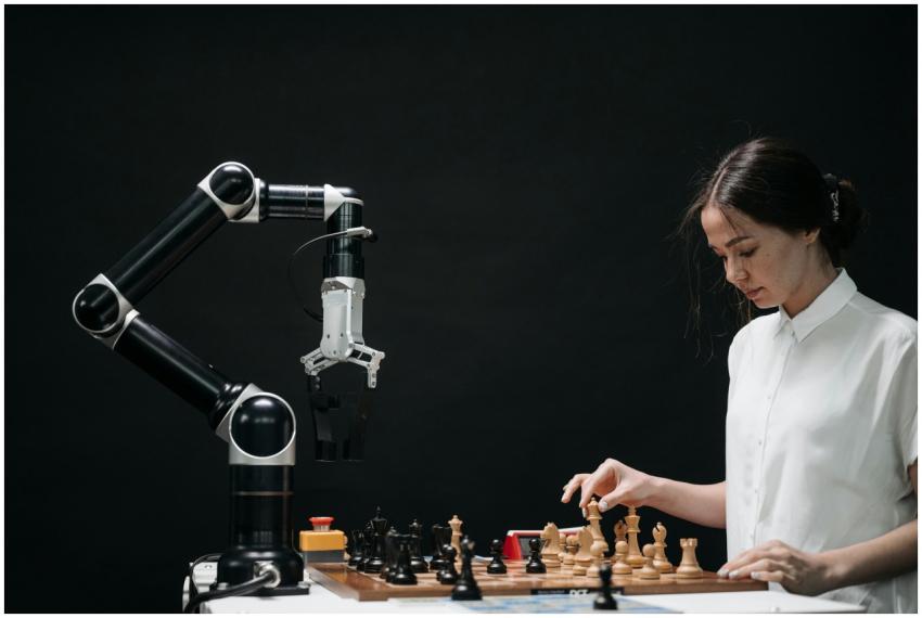 A woman plays chess against a robotic arm, showcas