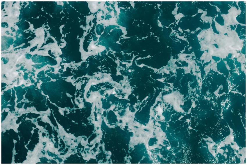 Dynamic aerial photograph of ocean waves with foam