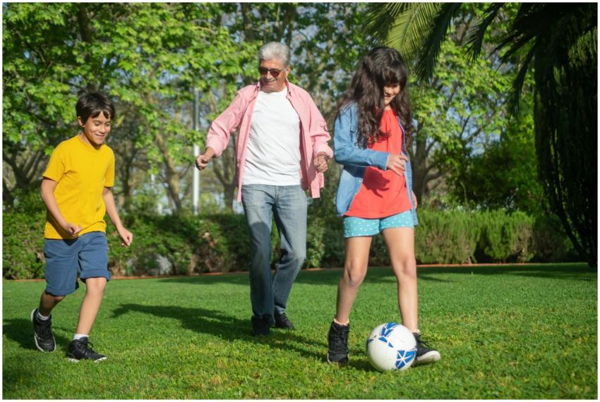 A joyful moment as a grandfather plays soccer with