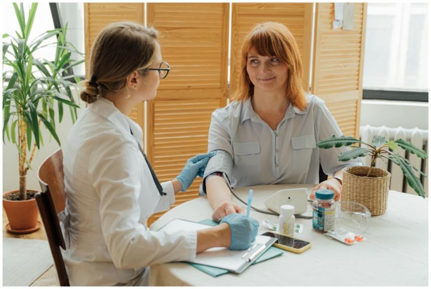 Doctor measuring patient's blood pressure with dig