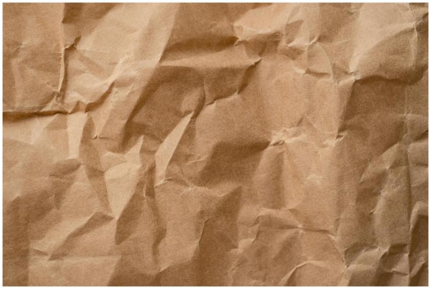 Close-up textured detail of a crumpled beige paper