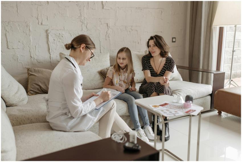 A doctor consults with a mother and daughter in a