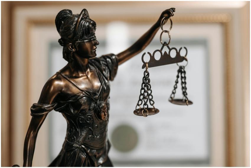 Close-up of a bronze Lady Justice statue holding s