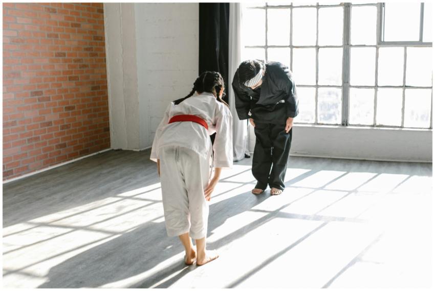 A child and instructor bowing during martial arts