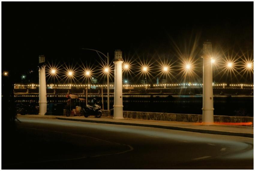 Beautiful nighttime view of a lights-covered bridg