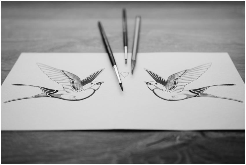 Monochrome bird illustration on paper with artist