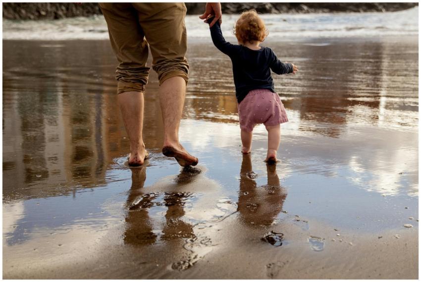 A father and toddler enjoy a sunny day walking bar