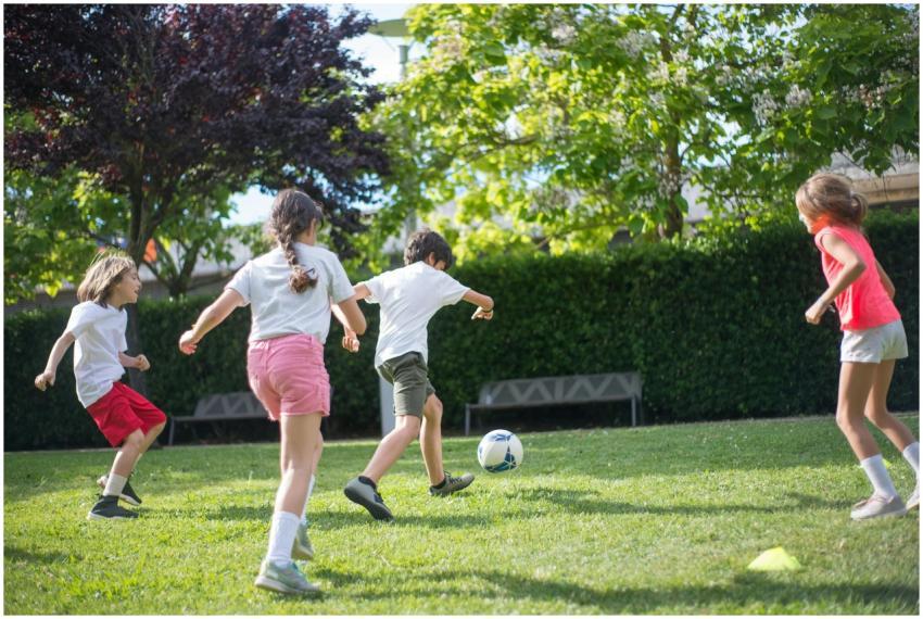 Group of kids enjoying a football game on a sunny