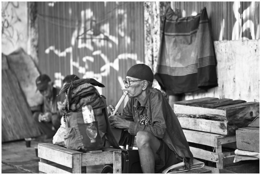 Candid black and white street photograph of elderl