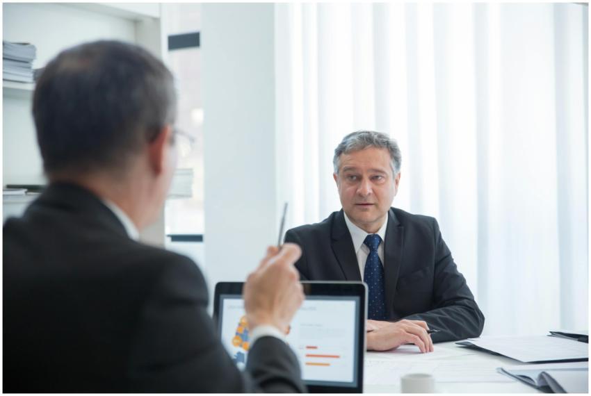 Business professionals in a focused discussion dur