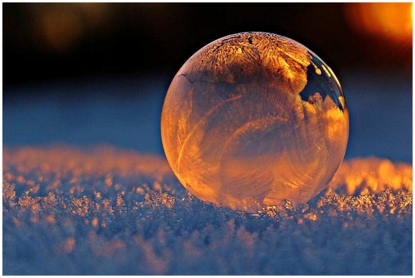 Close-up shot of a frozen bubble with warm reflect