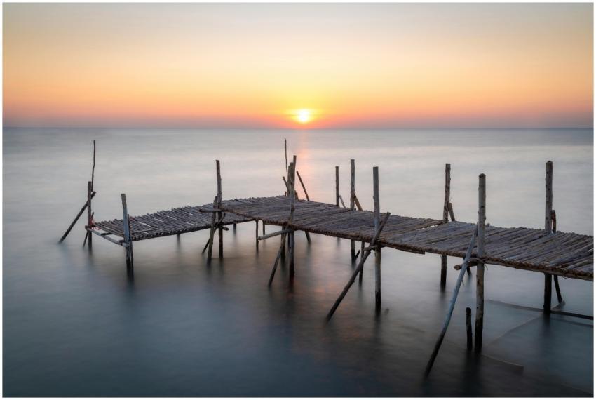 Captivating sunset over a wooden pier on a tranqui