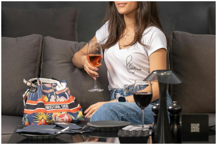 A woman relaxing on a sofa with wine at a stylish