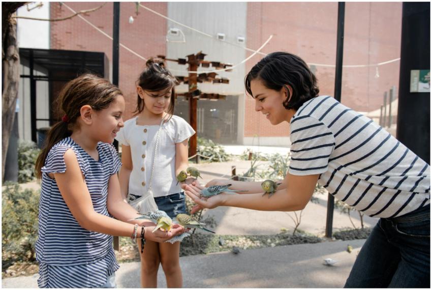 Two girls and a woman enjoying a playful moment wi