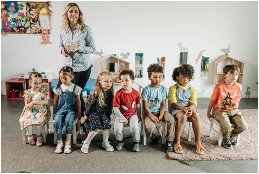 Children and teacher in a bright, diverse kinderga