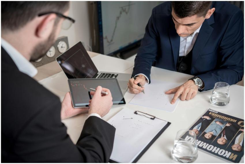 Two businessmen analyzing cryptocurrency market tr