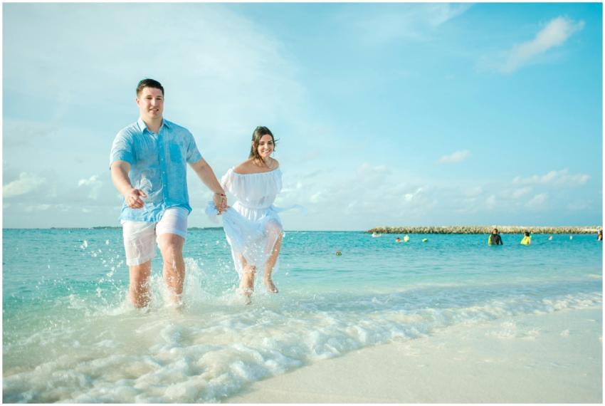 Happy couple running on the beach, enjoying a trop