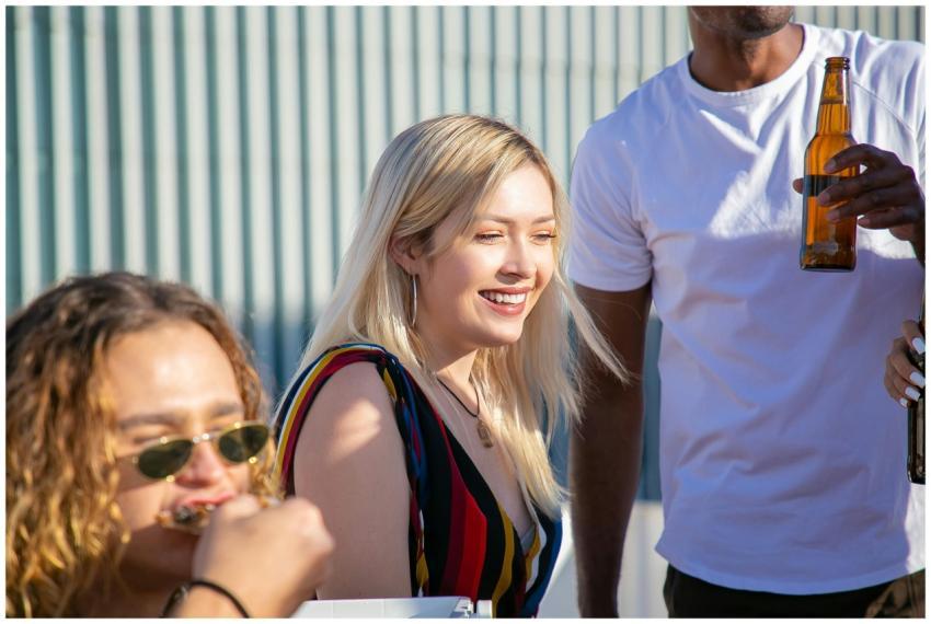 Group of diverse friends enjoying drinks outdoors