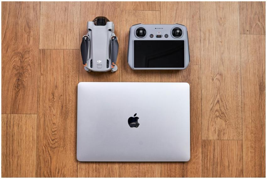 Overhead shot of a drone, controller, and laptop o