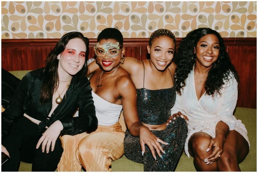 A lively group of friends in festive attire enjoyi