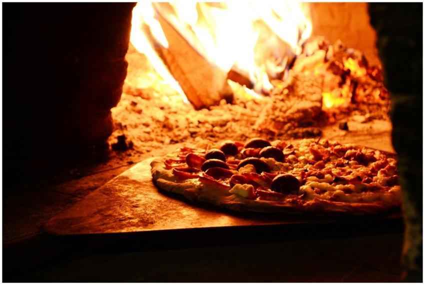 Delicious pizza baking in a traditional wood-fired