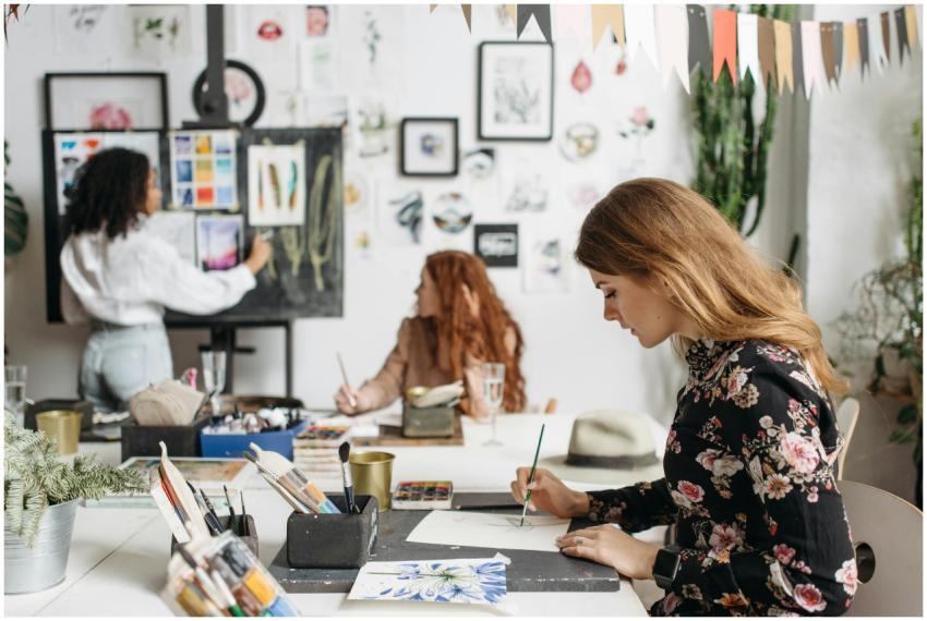 Women engaged in an art workshop with painting too