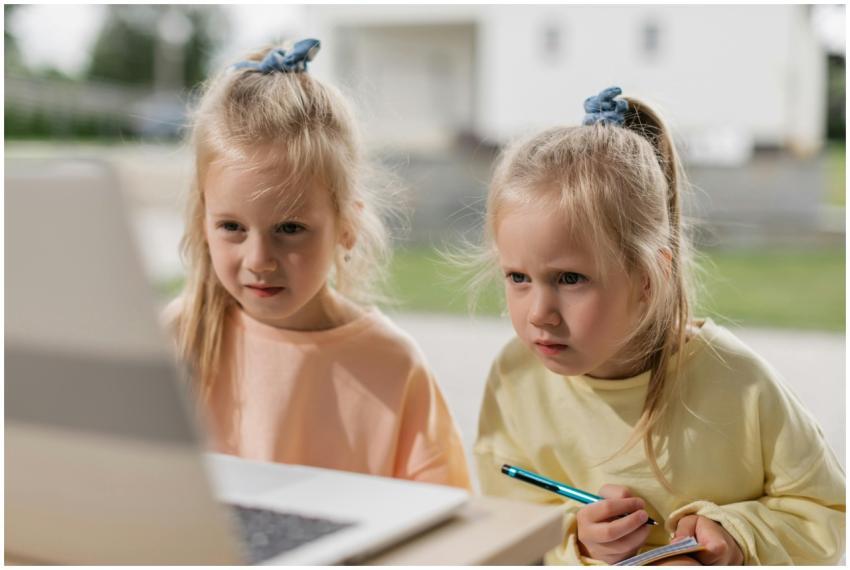Twin girls focused on an online learning activity