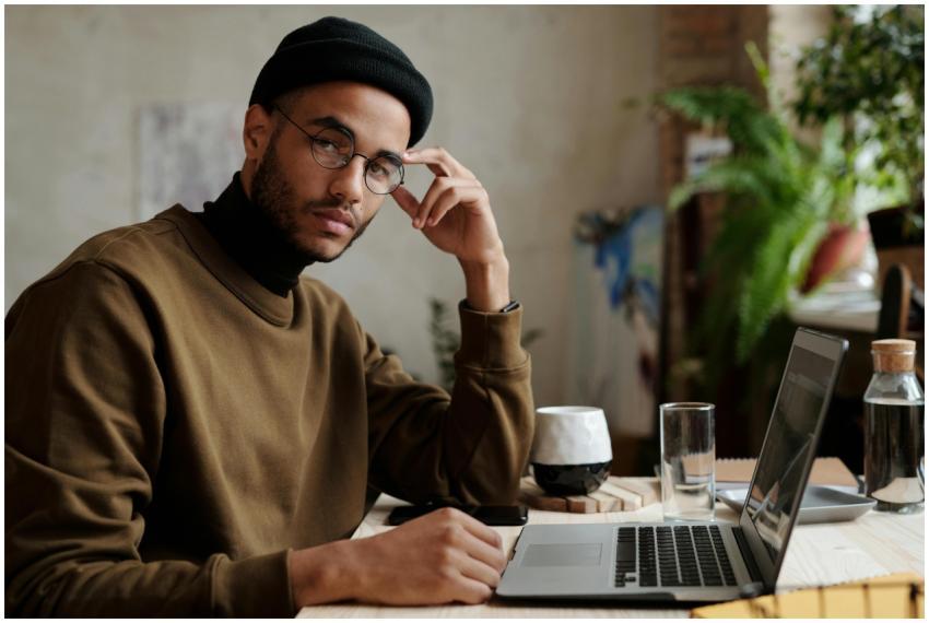 Stylish man working on a laptop from an indoor wor