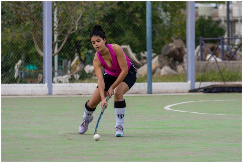 Dynamic shot of a female field hockey player in ac