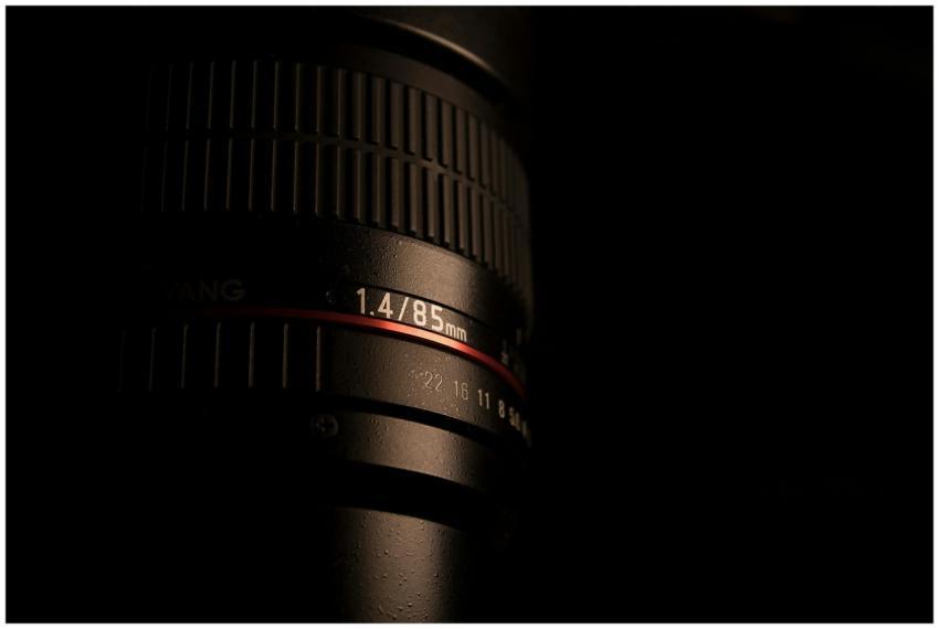 Detailed close-up of an 85mm camera lens showcasin