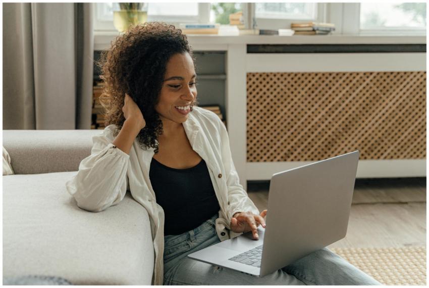 Smiling woman working from home on a laptop in a c