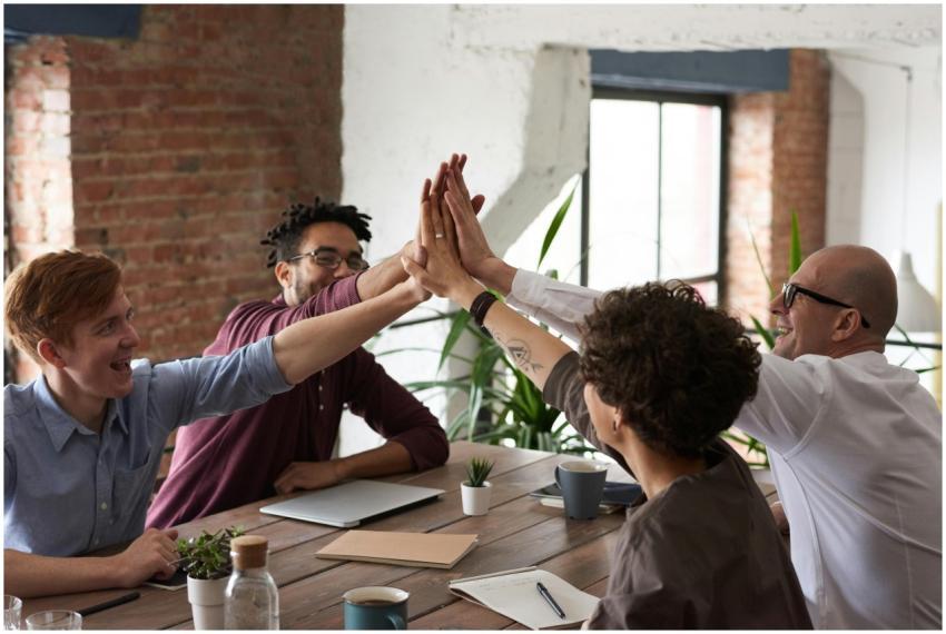 Diverse group of professionals giving a high-five