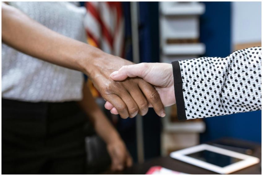 Close-up of two professionals shaking hands in a b