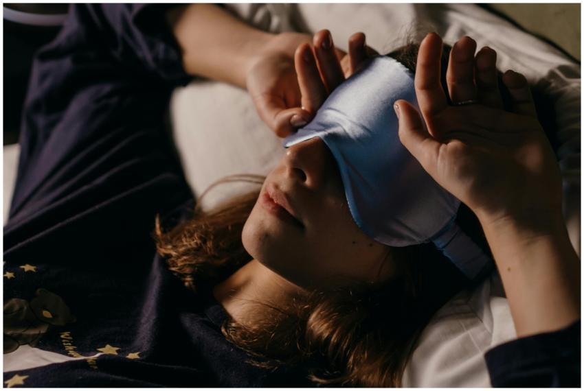 A woman resting at home wearing a sleep mask for a