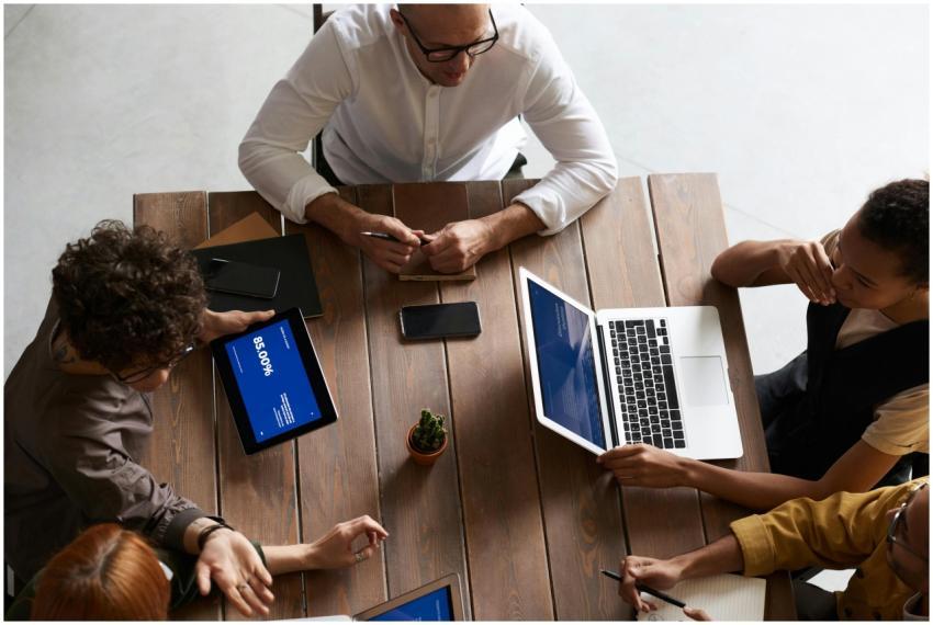 Top view of a diverse team collaborating with lapt