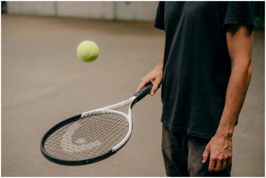 A man in a black t-shirt skillfully handling a ten