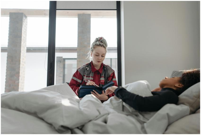 A healthcare worker takes notes while attending to