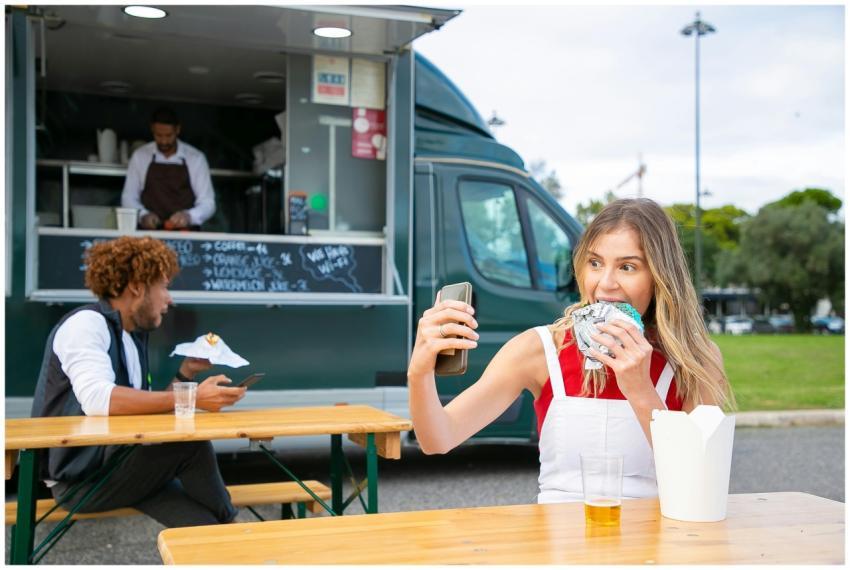 Cheerful young woman in casual clothes eating deli