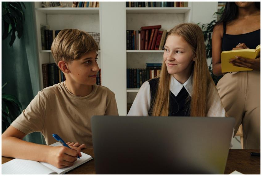 Group of teenagers studying together in a library