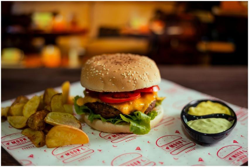 Mouthwatering cheeseburger with potato wedges and