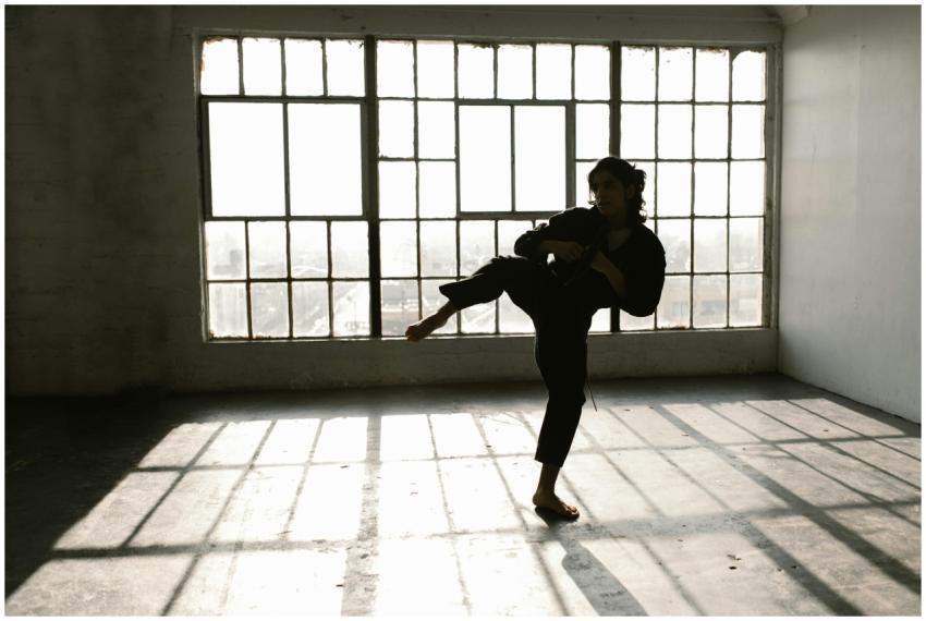 A martial artist in action, practicing kicks in a