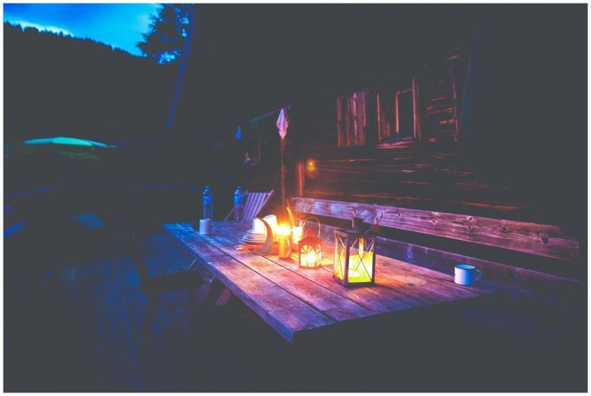 A charming outdoor scene with a candlelit table ou