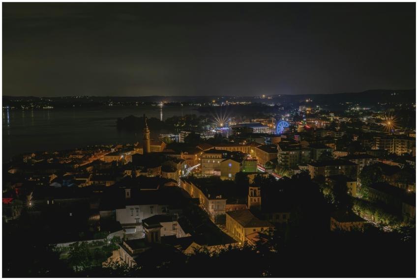 Stunning aerial shot of a city by a lake at night,