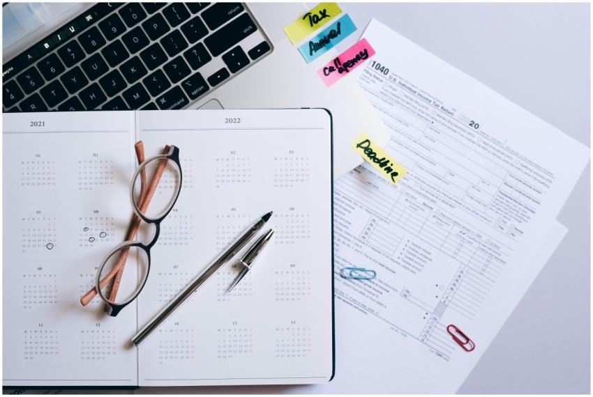 Organized workspace featuring a calendar, tax docu