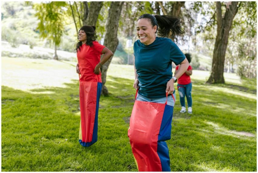 Adults participating in a fun sack race competitio
