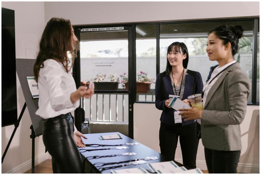 Businesswomen registering at a conference desk, sm