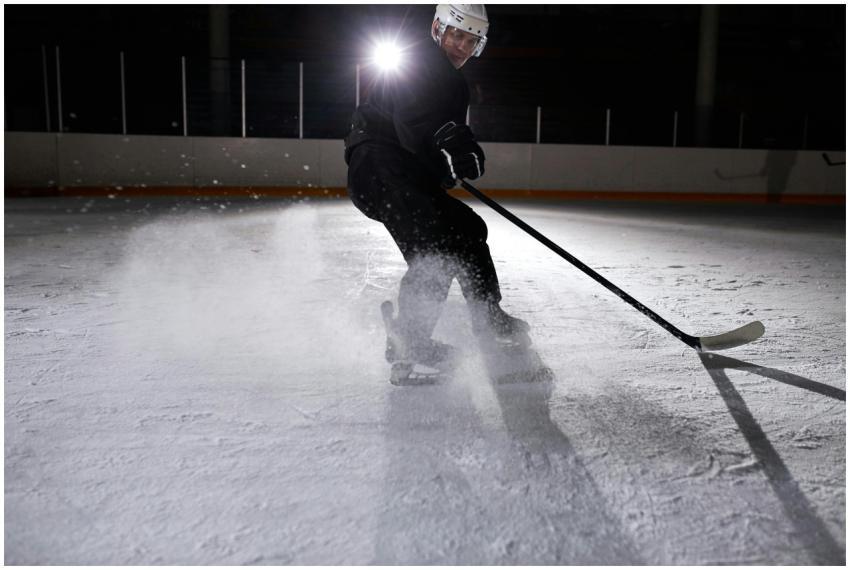 A skilled ice hockey player skates dynamically on