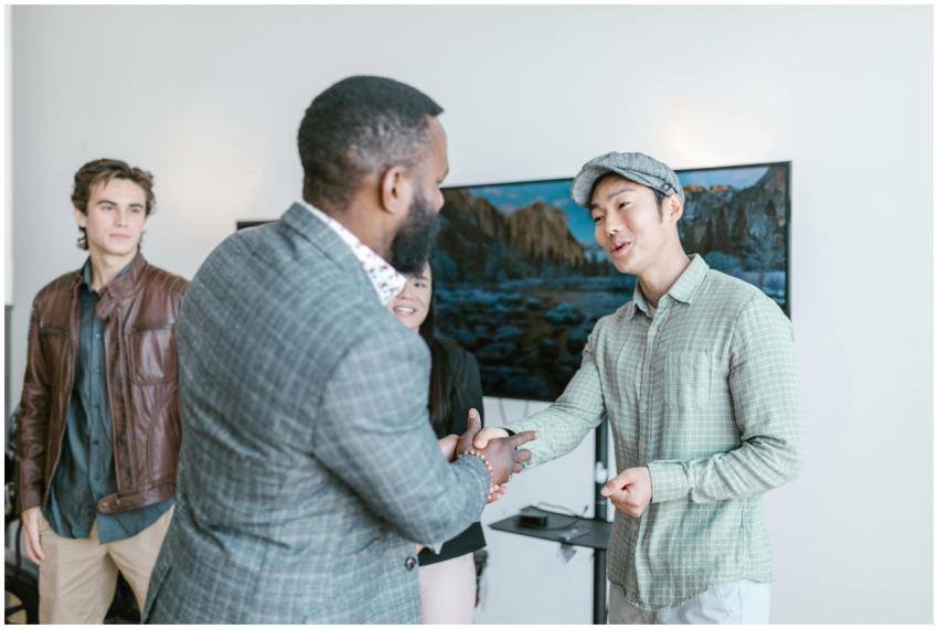 Diverse entrepreneurs engaging in a friendly hands