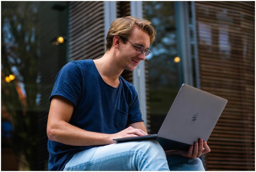 A young man sitting outdoors in Leiden, Netherland