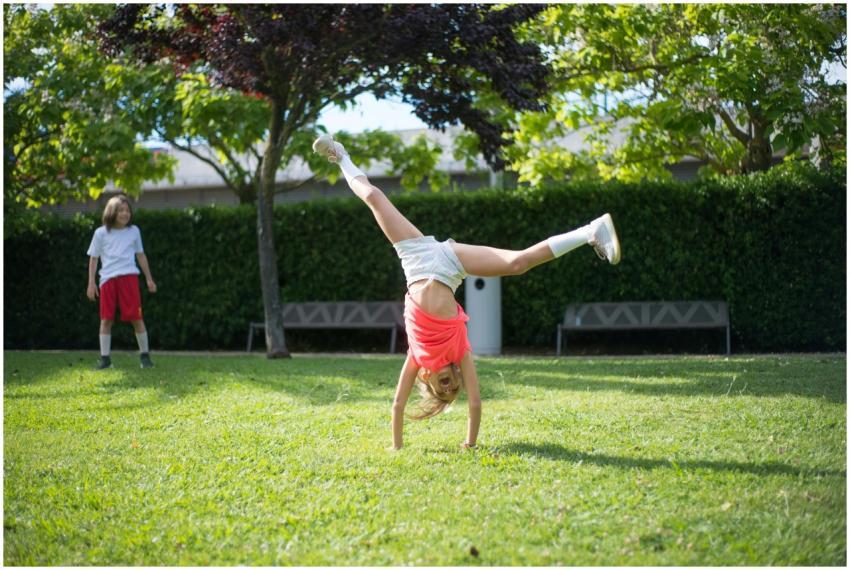 Two children playing in a sunny park, enjoying out